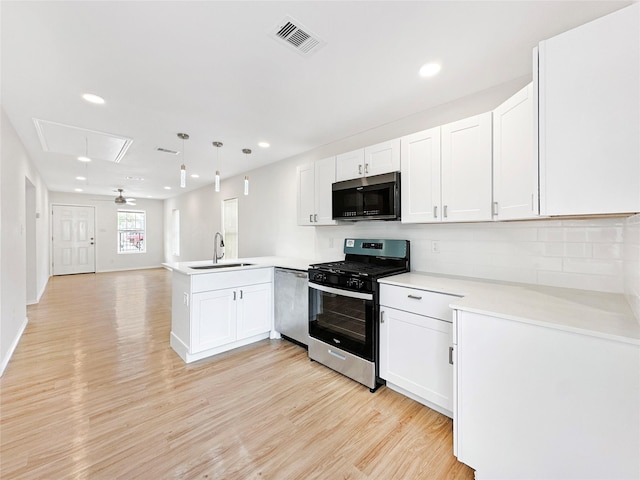 kitchen featuring kitchen peninsula, sink, white cabinets, and stainless steel appliances