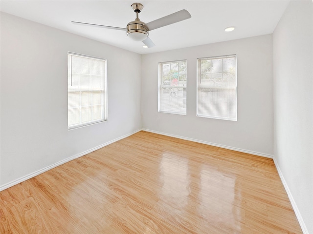 spare room with light wood-type flooring and ceiling fan