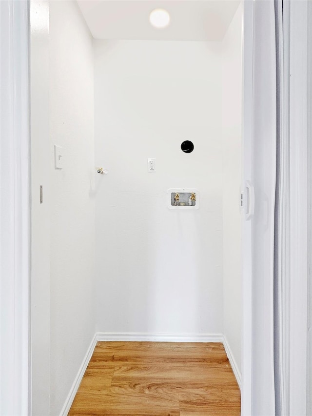 laundry area with hookup for a washing machine, hardwood / wood-style floors, and hookup for an electric dryer