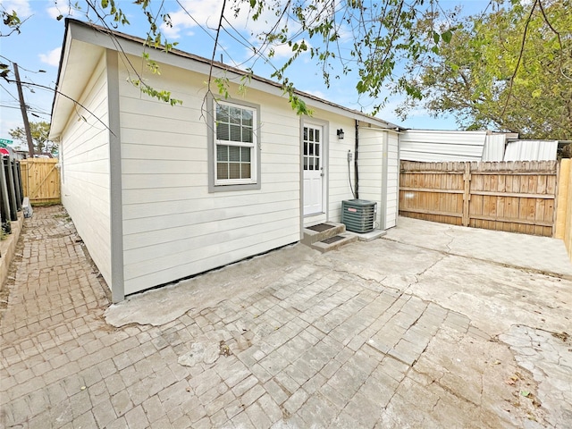 back of property featuring a patio area and central AC