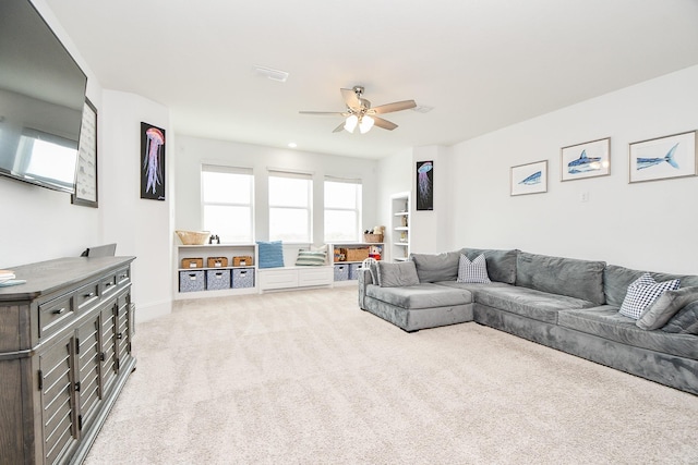 carpeted living room featuring ceiling fan