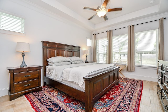 bedroom featuring light tile patterned floors, a raised ceiling, and ceiling fan