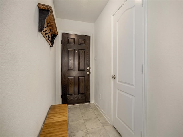 doorway with light tile patterned floors