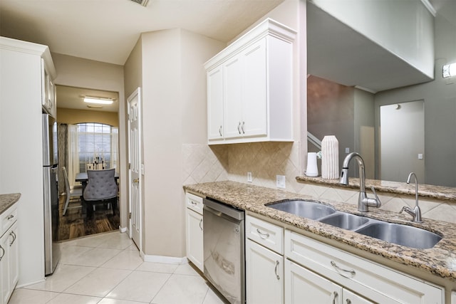 3102 Silver Cedar Trl, Katy, TX 77449 - kitchen with appliances with stainless steel finishes, a sink, light stone counters, and white cabinetry