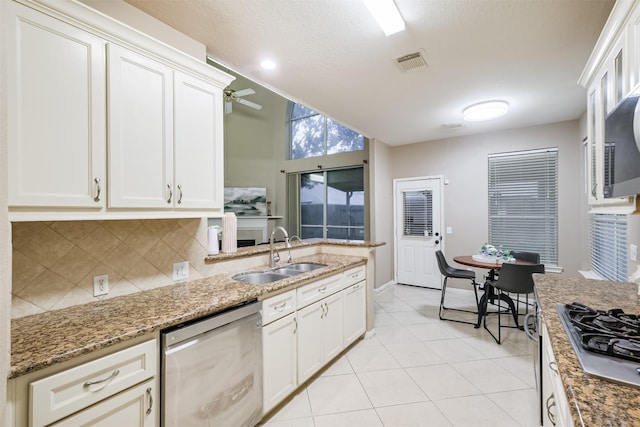 kitchen featuring ceiling fan, white cabinetry, sink, and stainless steel appliances