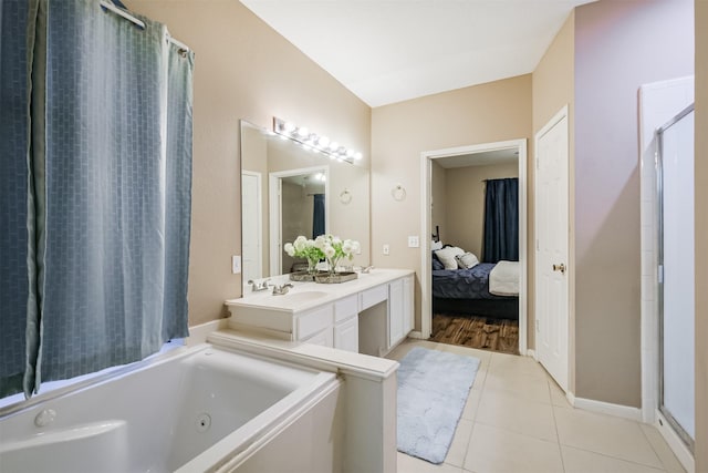 bathroom featuring tile patterned floors, a tub, and vanity