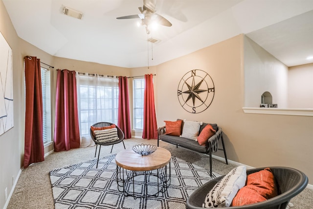 carpeted living room with ceiling fan