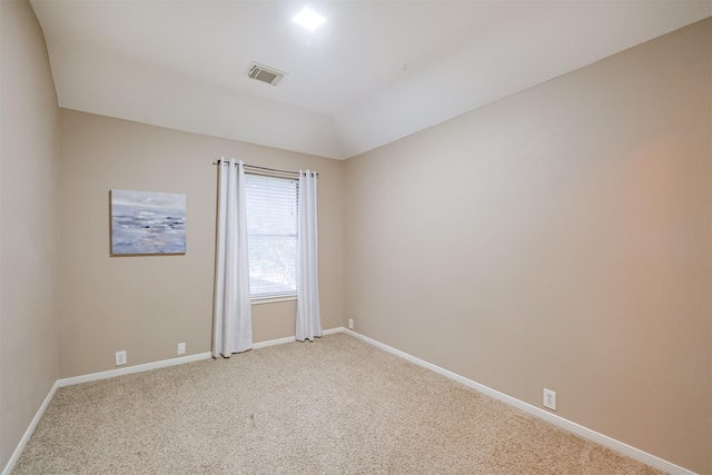 spare room featuring light colored carpet