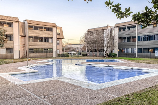 view of pool at dusk