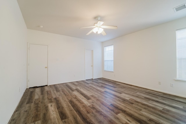 unfurnished room featuring dark hardwood / wood-style floors and a wealth of natural light