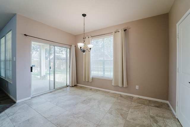 unfurnished dining area featuring plenty of natural light and a notable chandelier