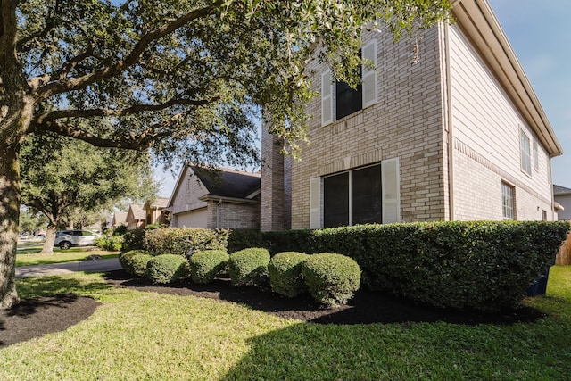 view of side of property with a yard