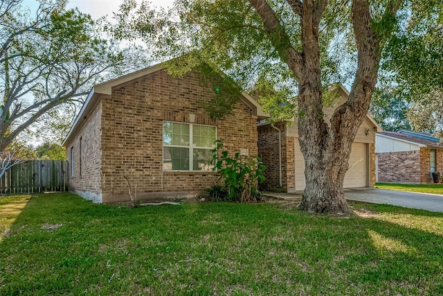 view of front of home with a garage and a front lawn