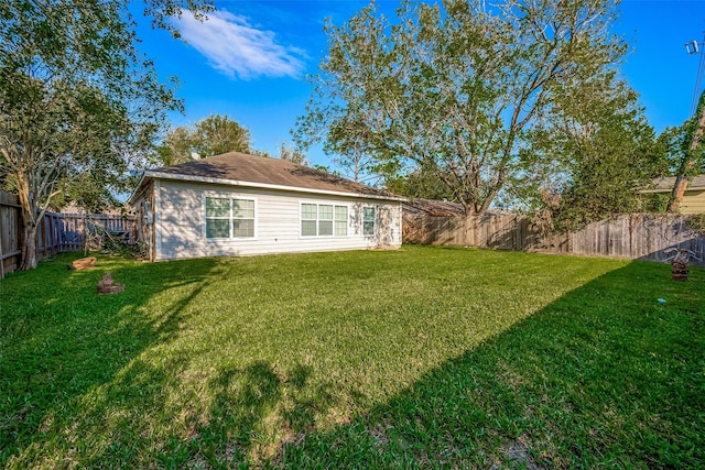 back of property featuring a lawn