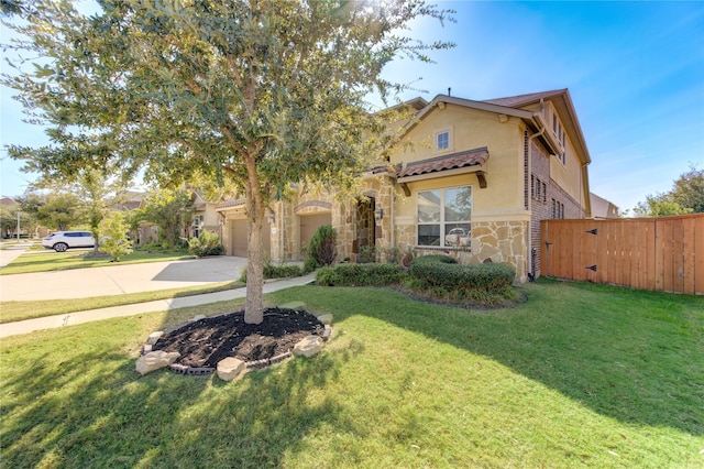 mediterranean / spanish home featuring a front lawn