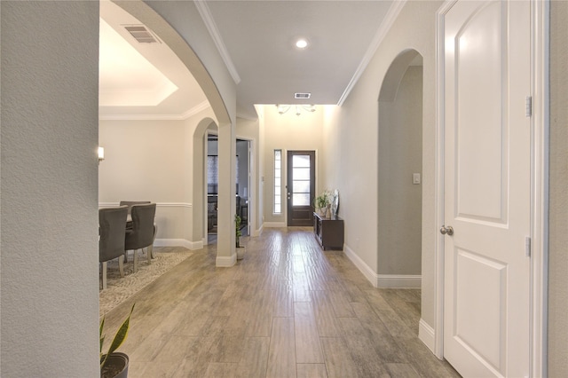 foyer entrance featuring light hardwood / wood-style flooring and ornamental molding