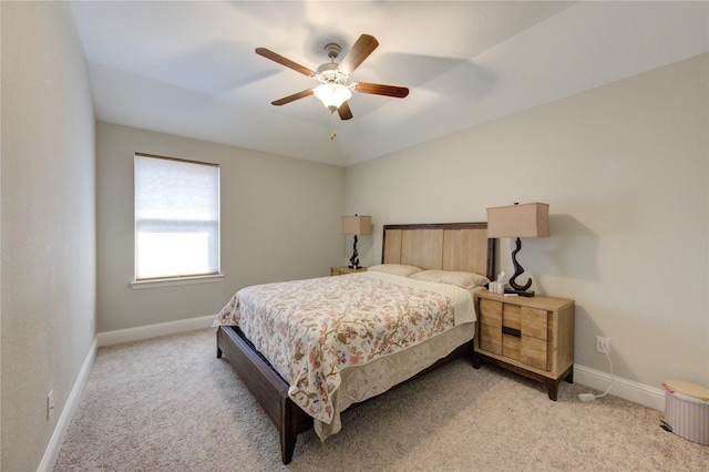 bedroom featuring ceiling fan and light carpet