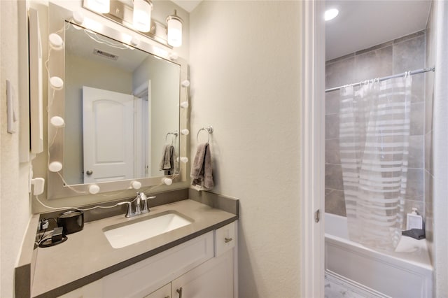 bathroom featuring vanity and shower / bathtub combination with curtain