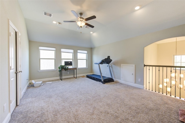 workout room with ceiling fan, light colored carpet, and lofted ceiling