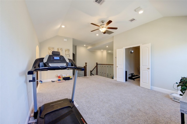 exercise room featuring carpet flooring and vaulted ceiling