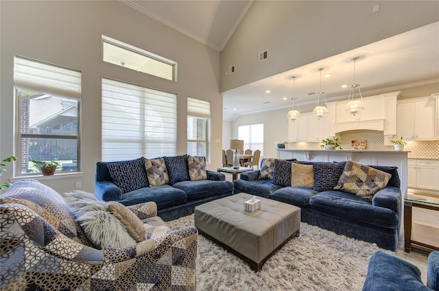 living room featuring light wood-type flooring, high vaulted ceiling, and ornamental molding