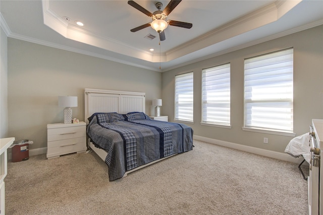 bedroom featuring light carpet, a raised ceiling, and ceiling fan