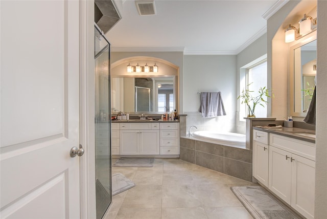 bathroom with tile patterned floors, crown molding, vanity, and shower with separate bathtub