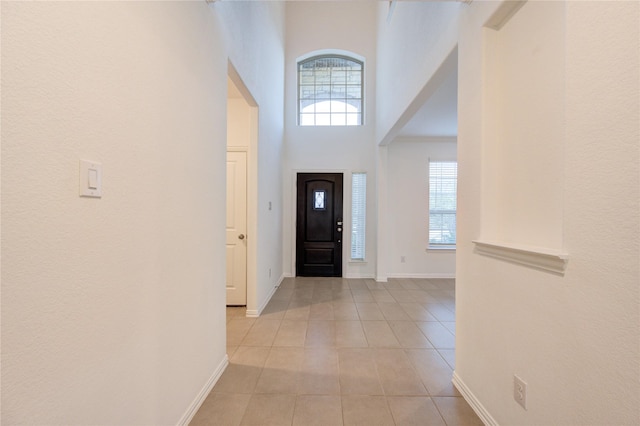 tiled entryway with a high ceiling