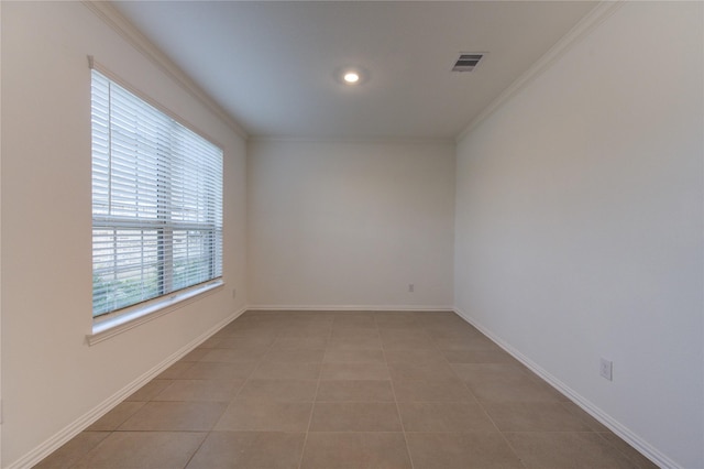 tiled spare room featuring ornamental molding