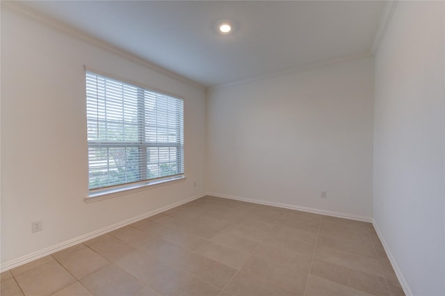 spare room with light tile patterned floors and ornamental molding