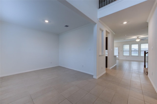 empty room with light tile patterned floors, ceiling fan, and crown molding