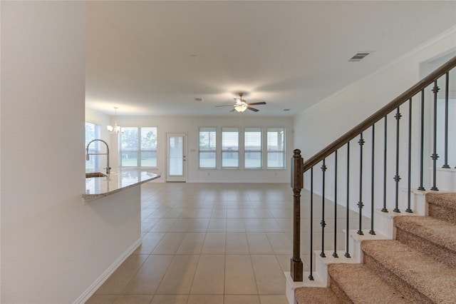 interior space with sink and ceiling fan with notable chandelier