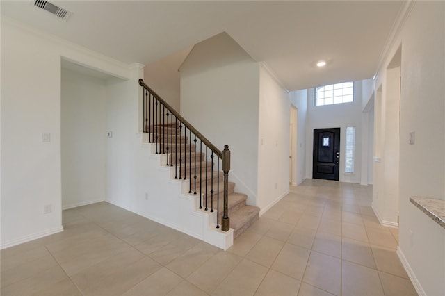 tiled foyer entrance with ornamental molding