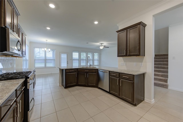 kitchen featuring kitchen peninsula, ceiling fan with notable chandelier, stainless steel appliances, and sink