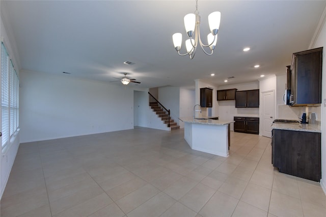 kitchen featuring light stone countertops, sink, light tile patterned flooring, and decorative light fixtures