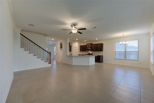 unfurnished living room with light tile patterned floors, ceiling fan with notable chandelier, and ornamental molding