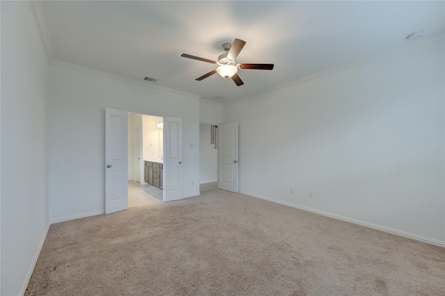 unfurnished room with light carpet, ceiling fan, and ornamental molding