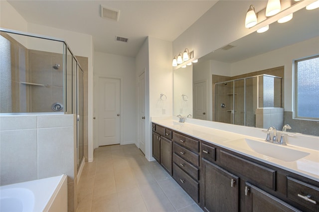 bathroom featuring vanity, tile patterned floors, and a shower with door