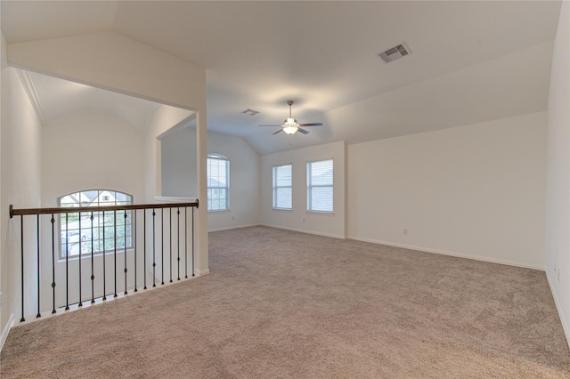 empty room featuring light carpet, ceiling fan, and lofted ceiling