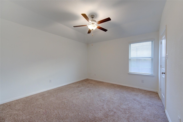 carpeted spare room featuring ceiling fan