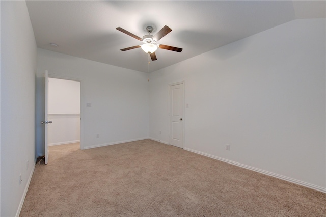 unfurnished room with ceiling fan, light colored carpet, and lofted ceiling