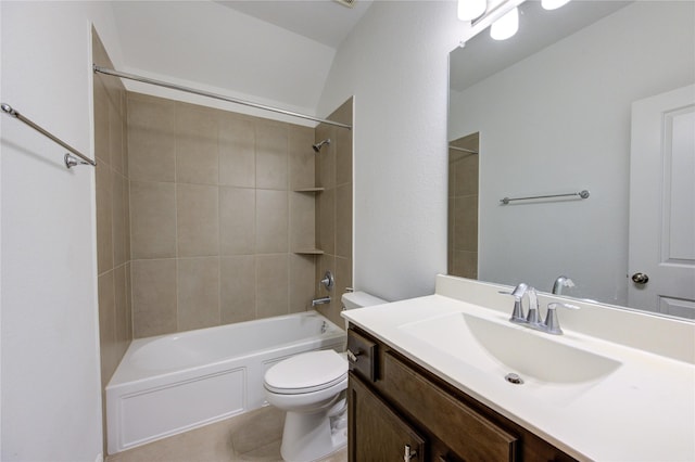 full bathroom featuring vanity, tiled shower / bath combo, and toilet