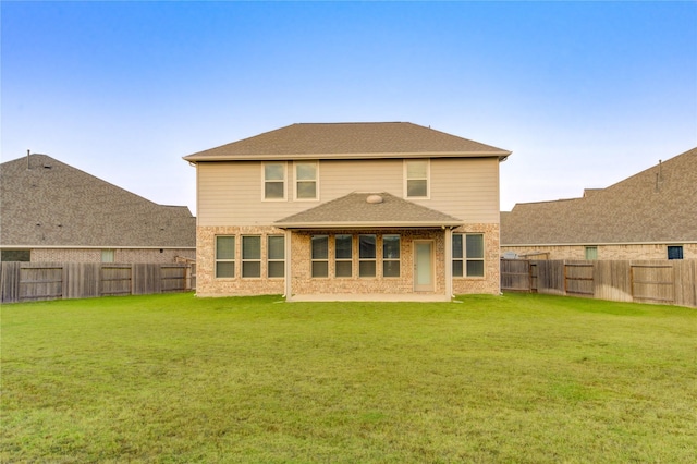 back of house with a lawn