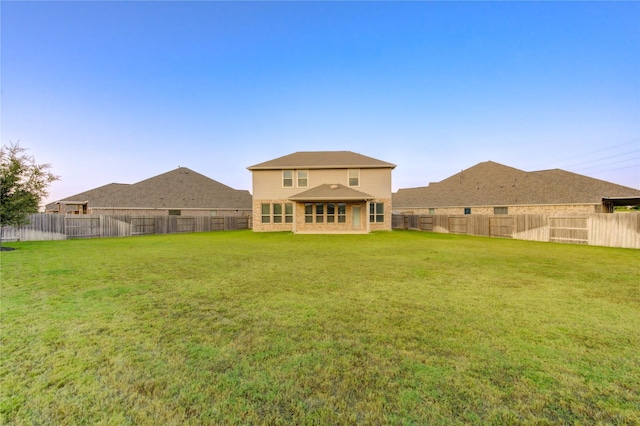 rear view of house with a yard