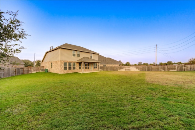 back of property featuring a lawn