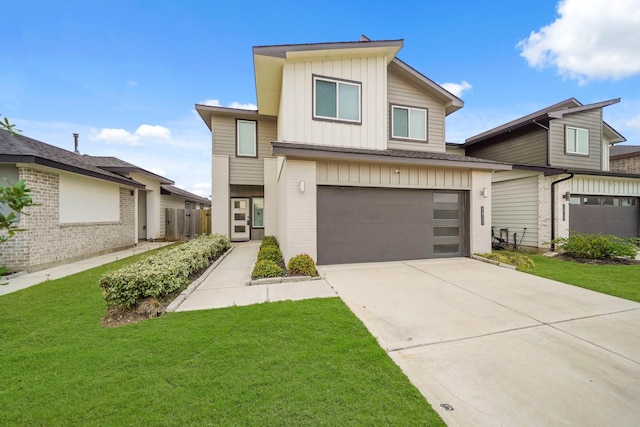 view of front facade featuring a front yard and a garage