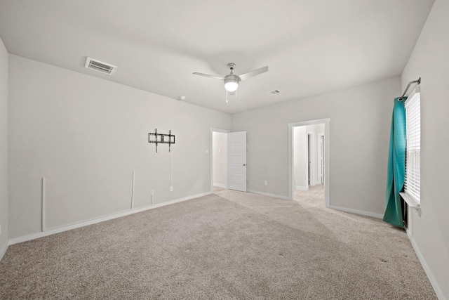 empty room with ceiling fan and light colored carpet