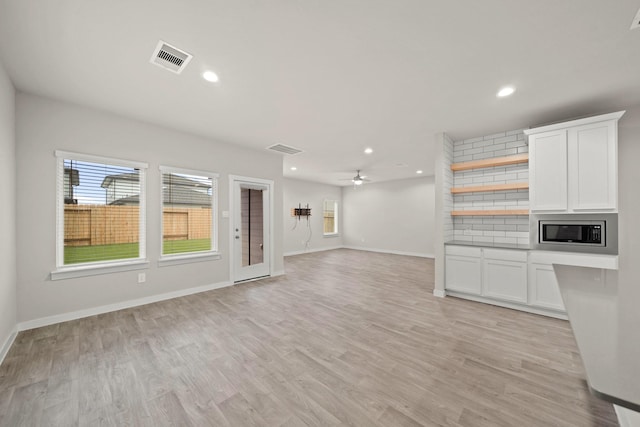 unfurnished living room with light hardwood / wood-style floors and ceiling fan