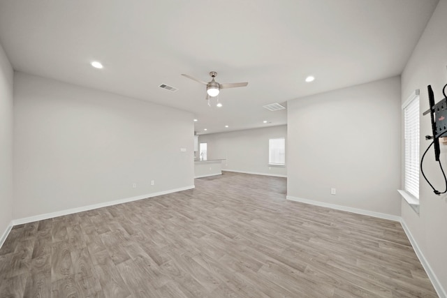 unfurnished living room with ceiling fan and light hardwood / wood-style floors