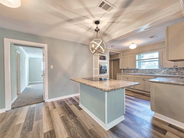 kitchen with pendant lighting, backsplash, dark wood-type flooring, a kitchen island, and light stone counters